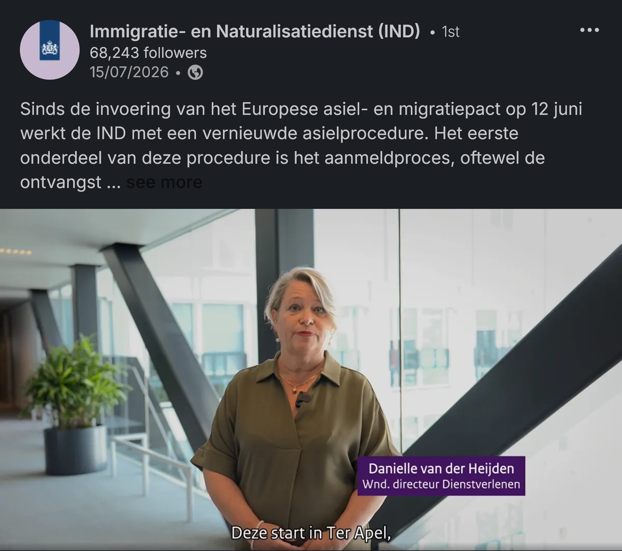 Video still: Danielle van der Heijden, acting director of Services at the IND, speaking in a light office atrium. On-screen subtitle reads 